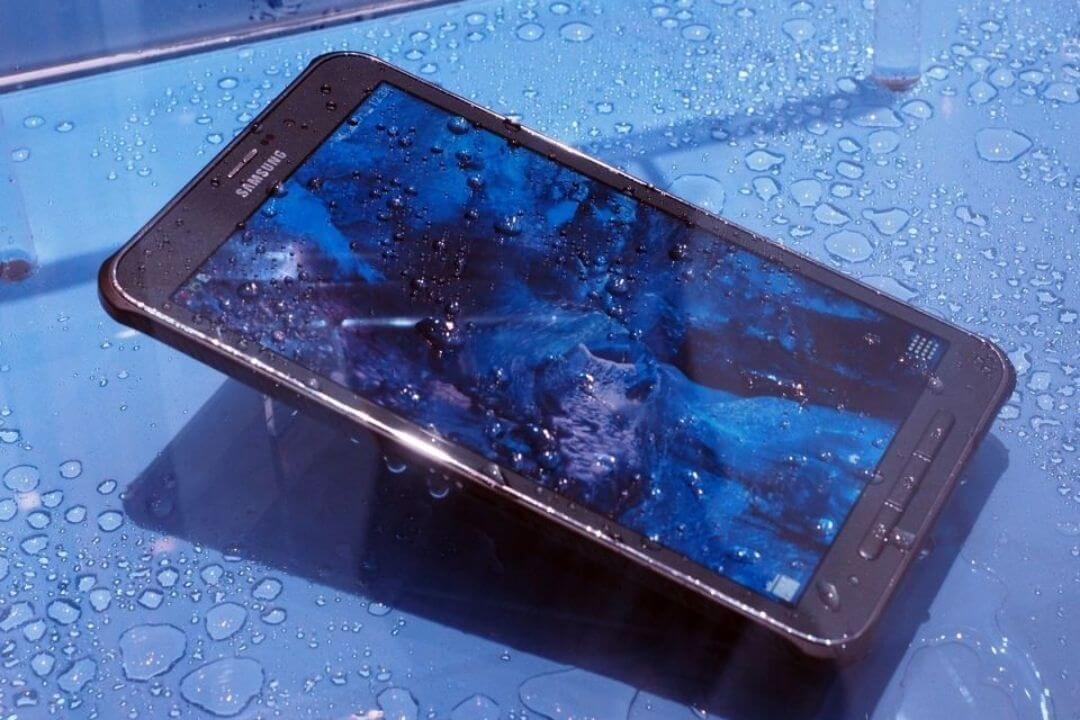 Technician inspecting a tablet for water damage